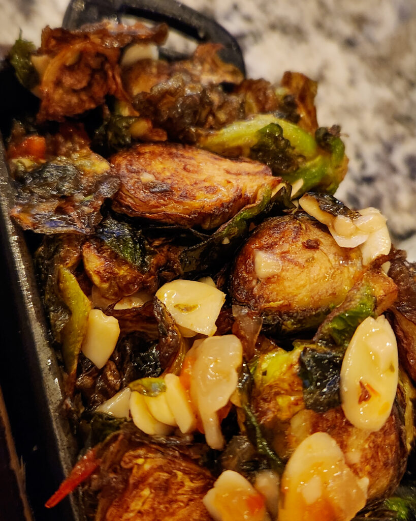 CHARRED BRUSSEL SPROUT In a sweet peppadew sauce with sliced almonds.