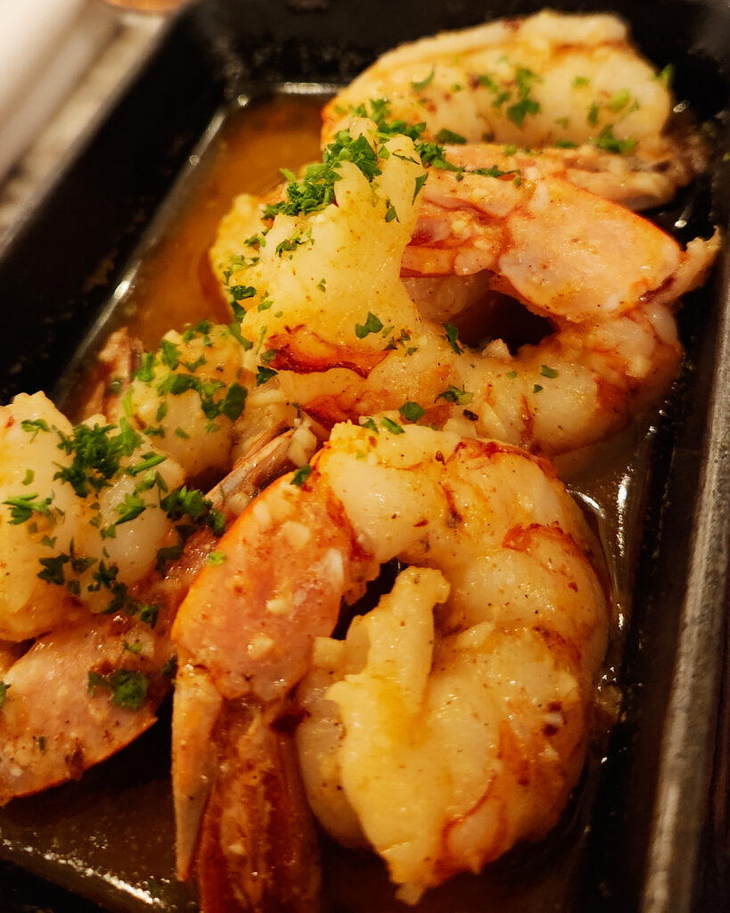 SHRIMP AL AJILLO Wild-caught Argentine Red shrimp in garlic, olive oil, paprika, and chiles.